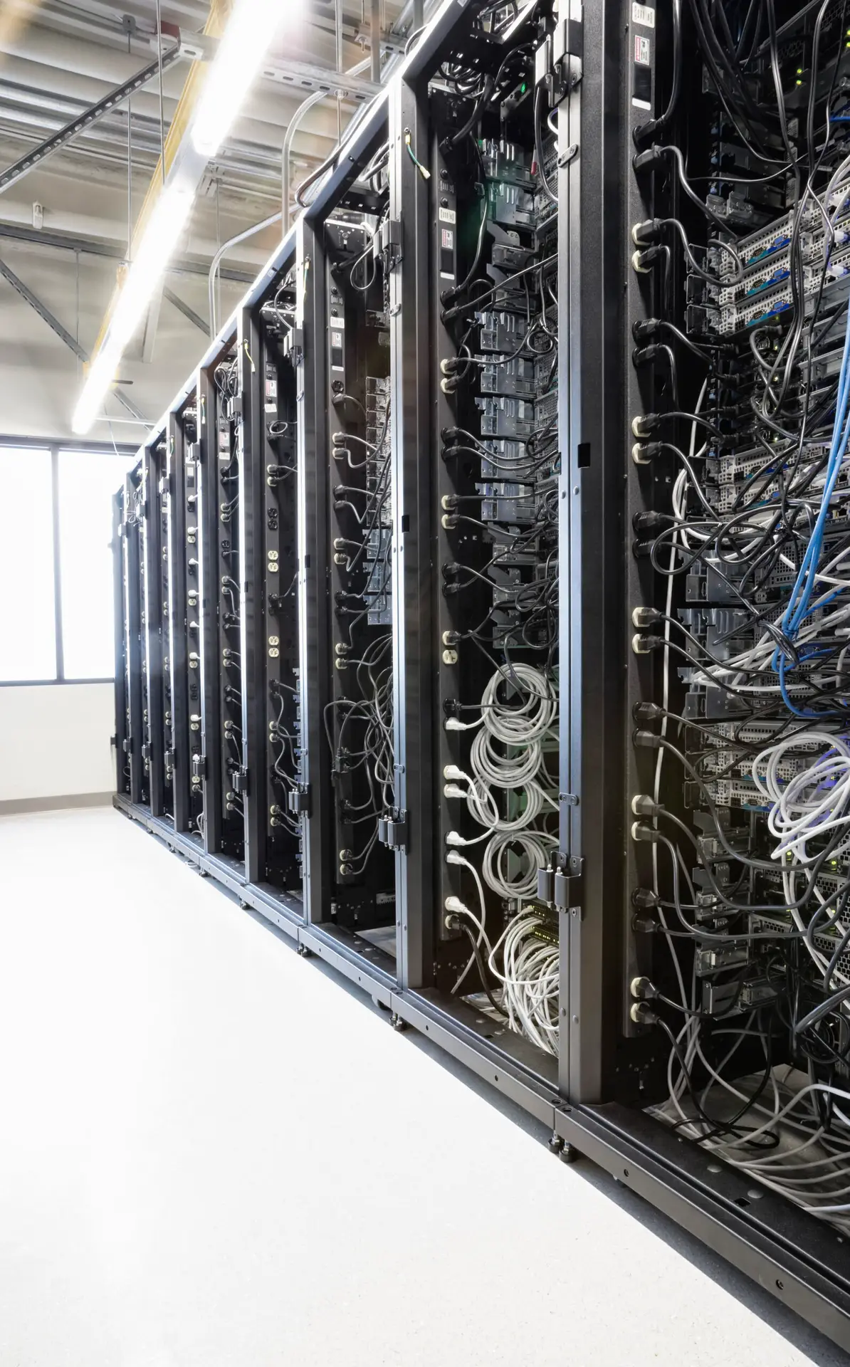 Rows of server racks and cabling in a data centre aisle