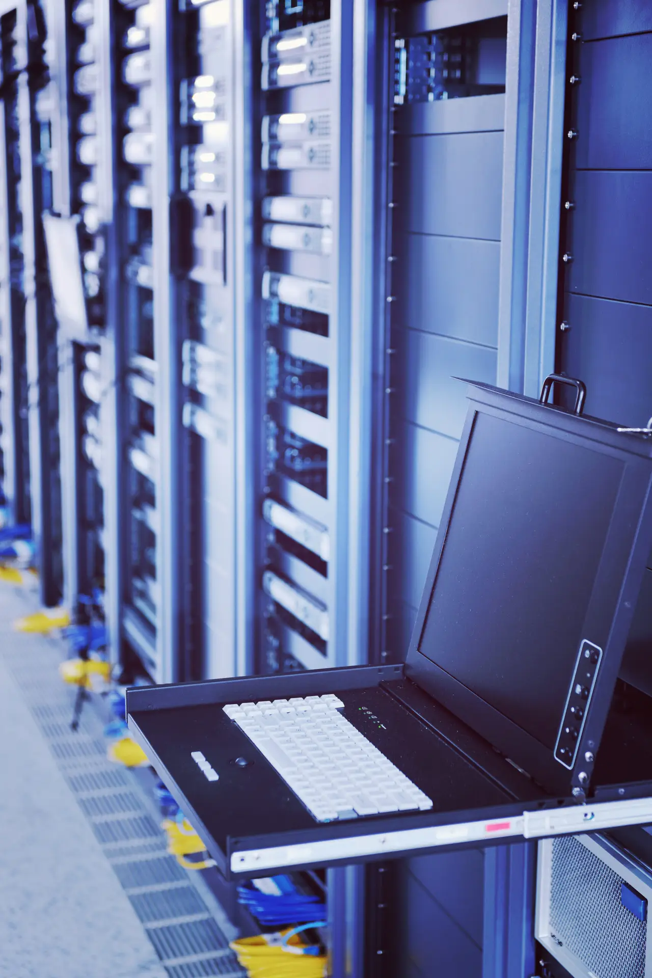 Network server room with equipment racks lit in blue